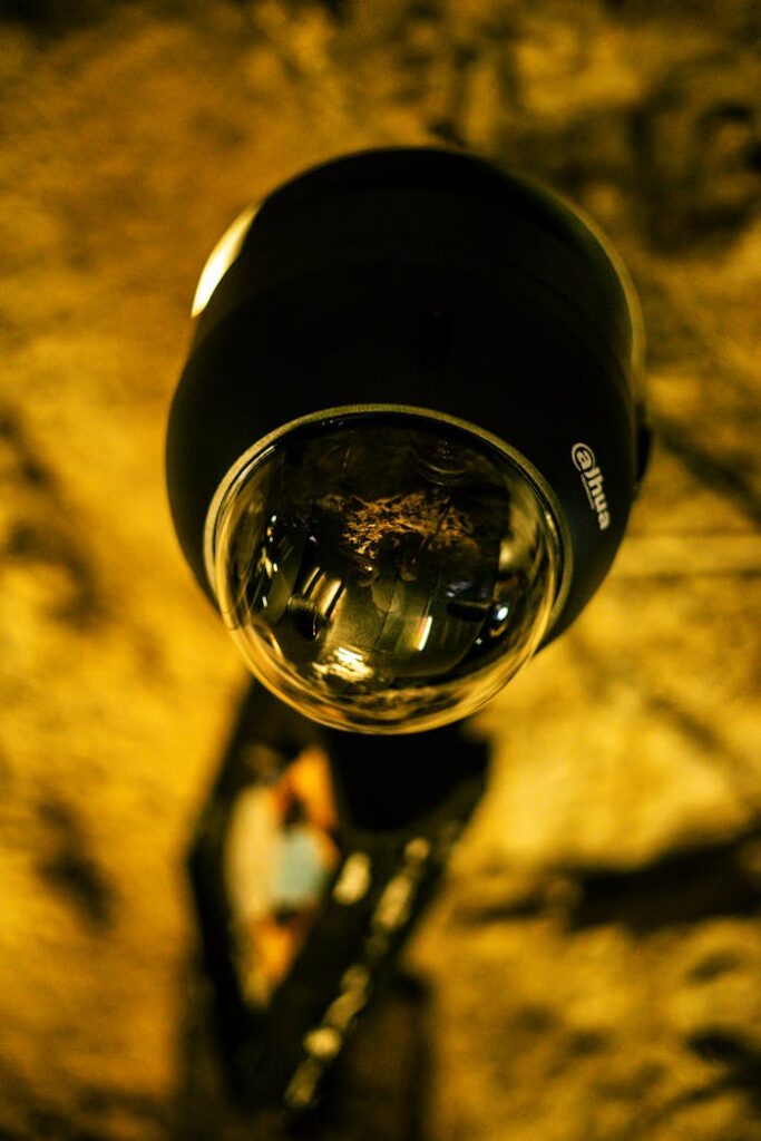 Detailed close-up image of a security surveillance camera lens indoors.